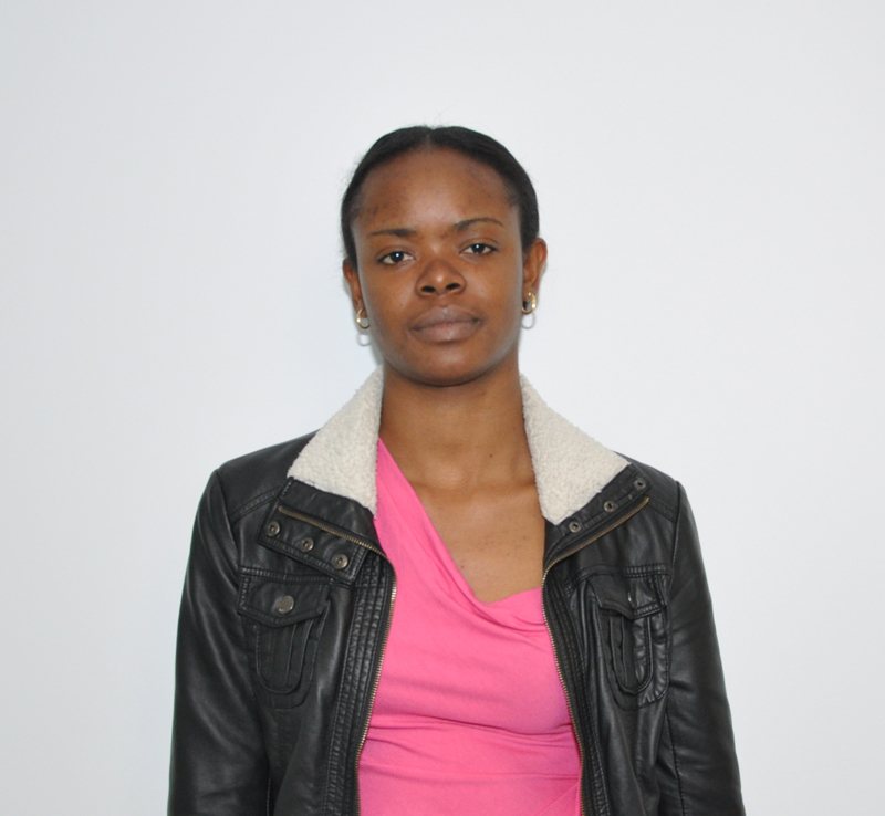 Portrait of a woman wearing a pink shirt and black leather jacket
